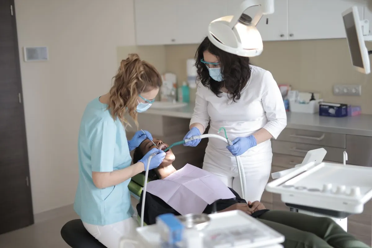 Dentist and assistant examining a patient in a modern clinic