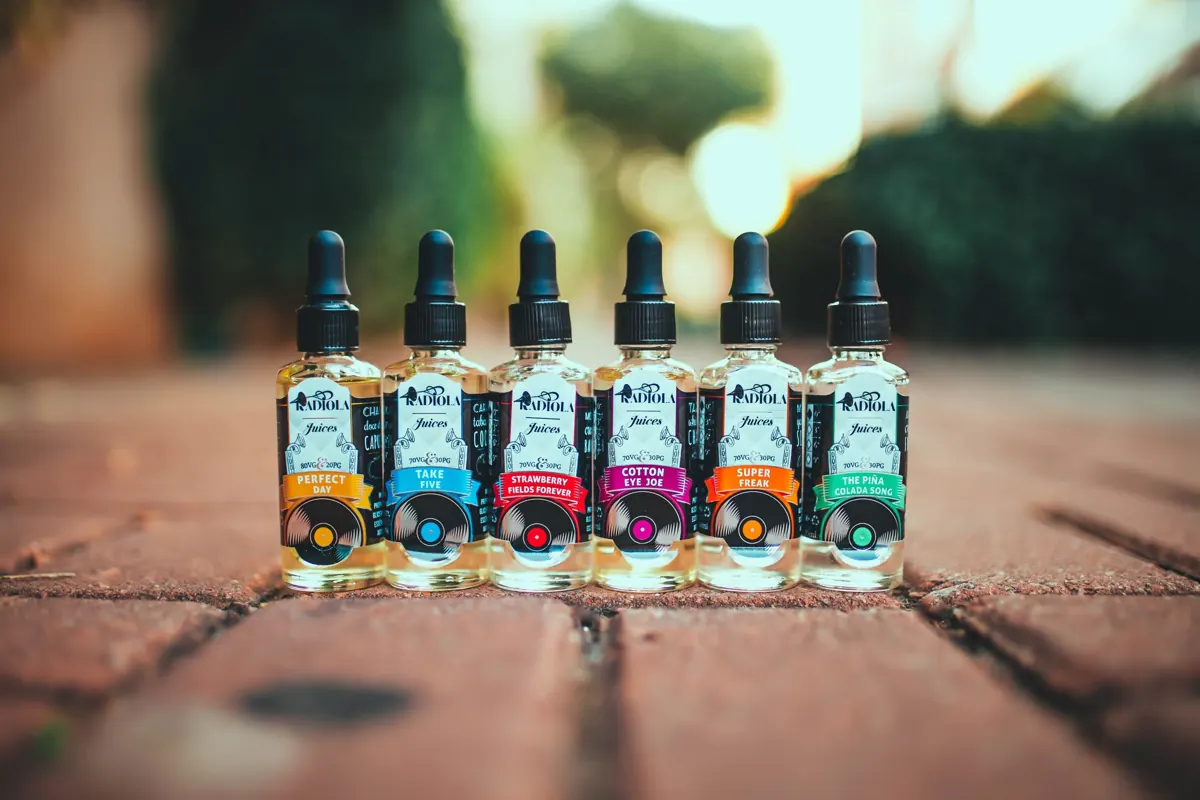 Bottles of e-liquid in a row on a shelf