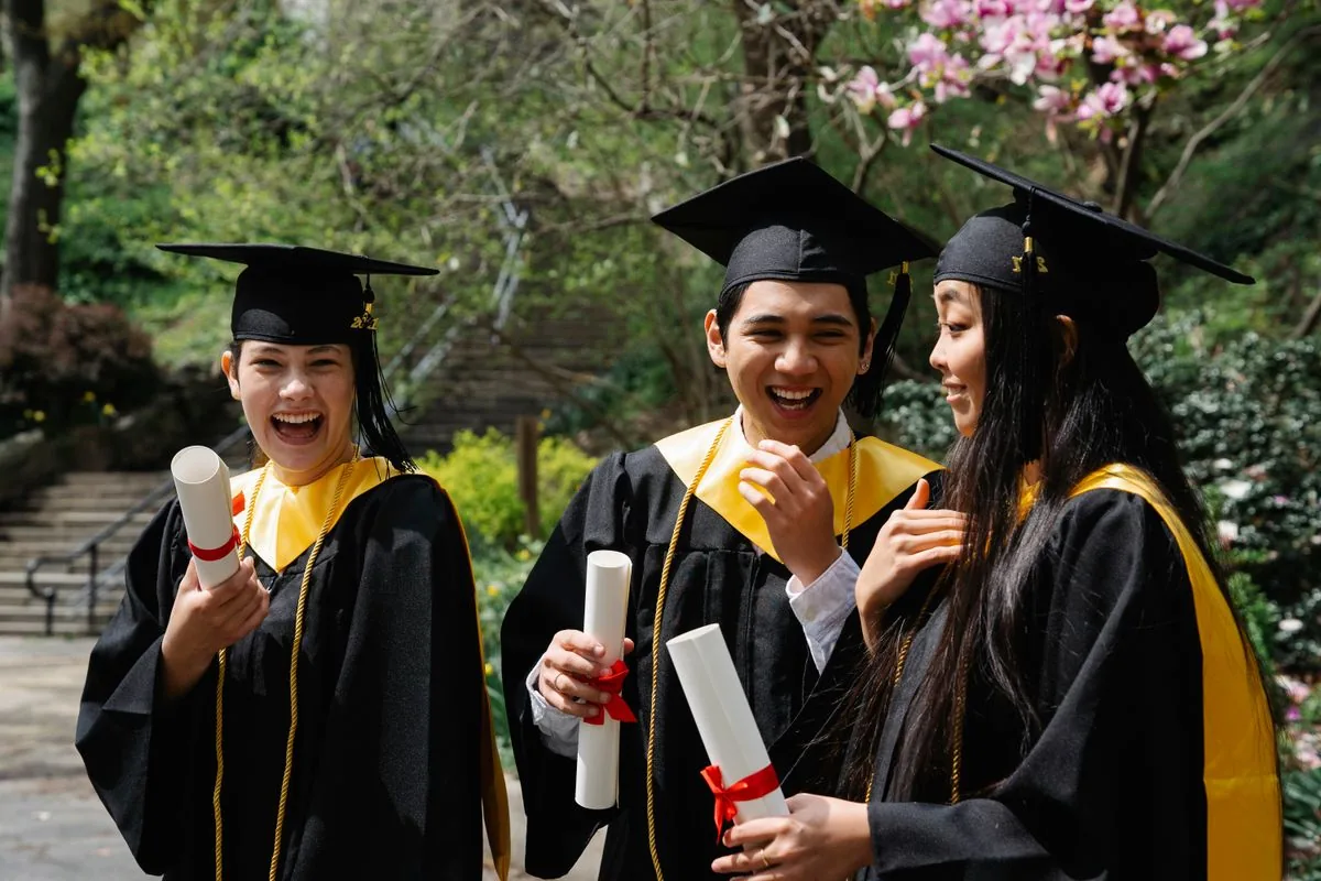 Graduates holding their diplomas