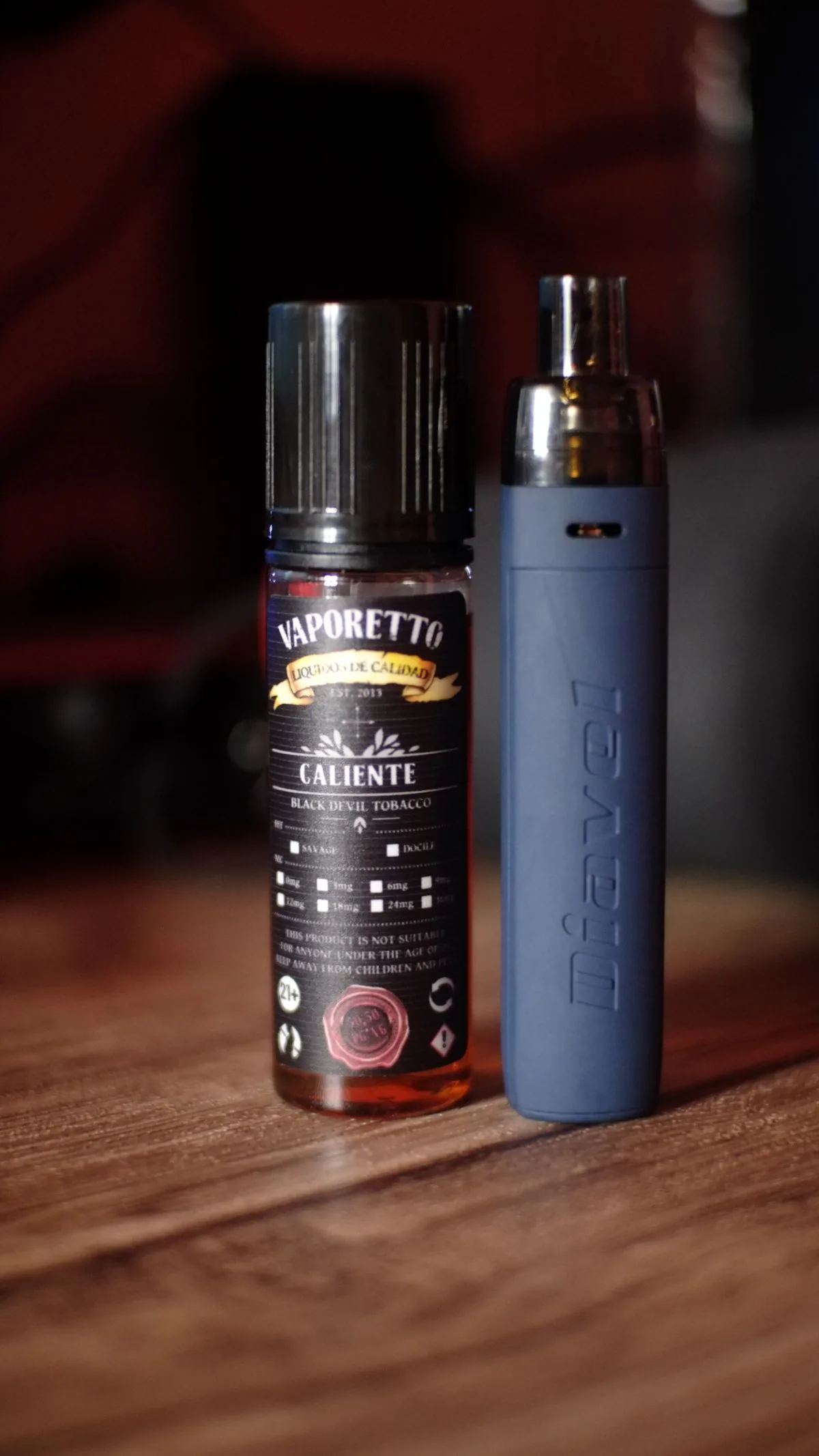 Vape device and e-liquid on a wooden table